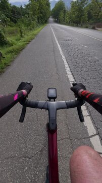 View from cyclist's handlebars on open road, showcasing adventure and freedom in outdoor cycling.