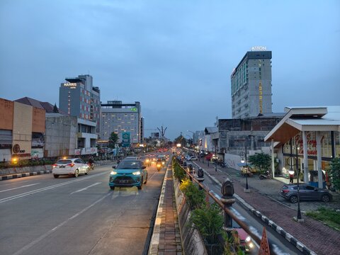 Busy evening traffic and modern hotels on the main city street of Surakarta, Central Java, Indonesia. 28 February 2026.