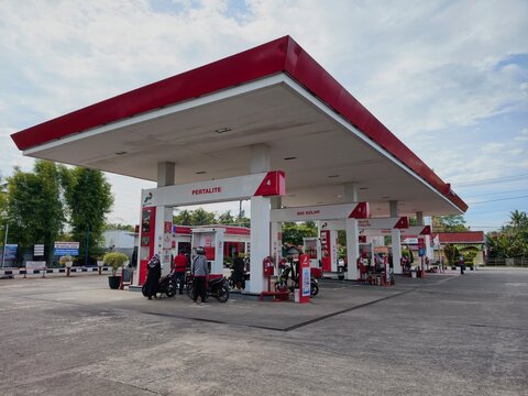 Local motorcyclists refuel at a Pertamina gas station under a cloudy sky in rural Kebumen, Indonesia. 03 April 2026.