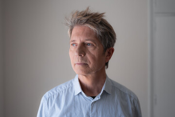 Obraz premium Mature man thoughtfully looking away contemplating decision