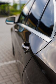 Modern luxury car close up detail of sleek body lines, metallic blue vehicle design with elegant textured elements