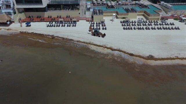 Aerial view of a backhoe on the beach in Playa del Carmen, Mexico