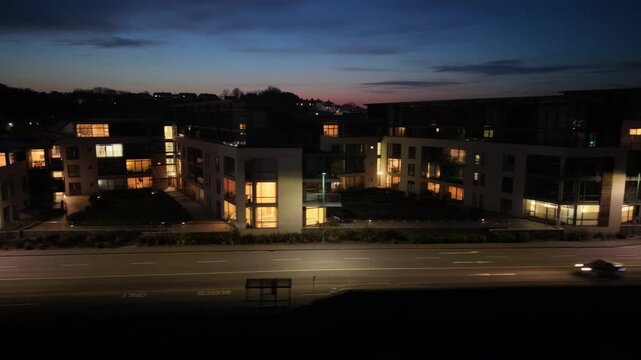 Admiral Park St Peter Port Guernsey.Sunset drone footage along Les Banques showing Vega Apartments,Martello Court and Dorey Court lit up with deep pink sky