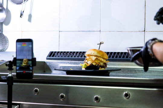 Creating social media food content with a gourmet burger and smartphone