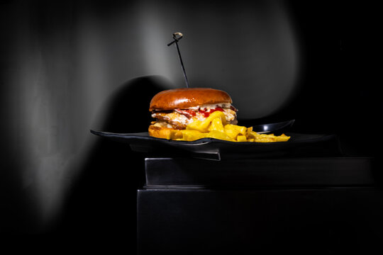 Gourmet burger with french fries and a bun, presenting a sophisticated fast food meal