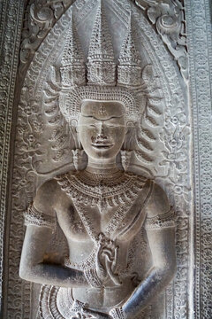 Devata carving on a stone wall at Angkor Wat