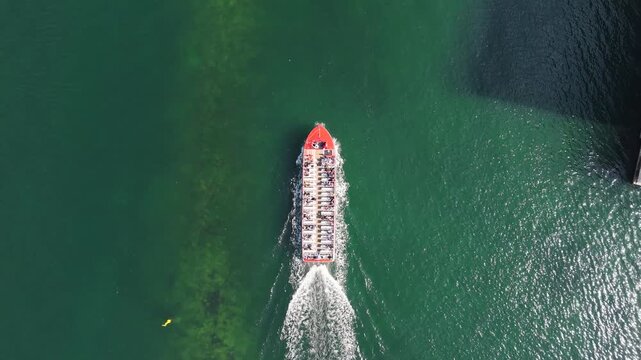 Bird's-eye view of red tourist boat in canal, Copenhagen, Denmark