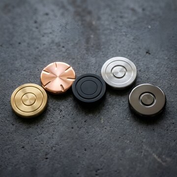 Collection of Five Metal Fidget Spinners on Dark Textured Background