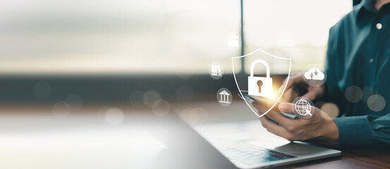 Business professional using smartphone with cybersecurity shield interface, mobile data protection, cloud security, secure communication, privacy management, information security, cyber defense, © ภัทรชัย รัตนชัยวงค์