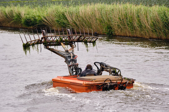 Water management and canal maintenance maaiboot waterschap clearing weeds in westfriesevaart canal middenmeer netherlands environmental protection