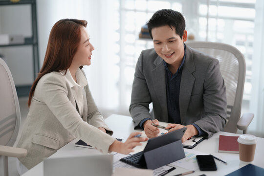 Asian office employee supervising Mentor training trainee at office