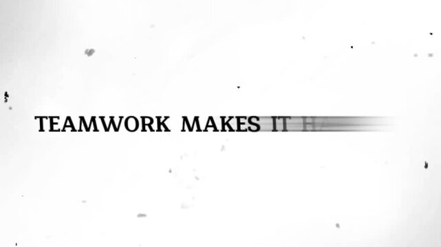 Blurry teamwork text on white background with black specks scattered around
