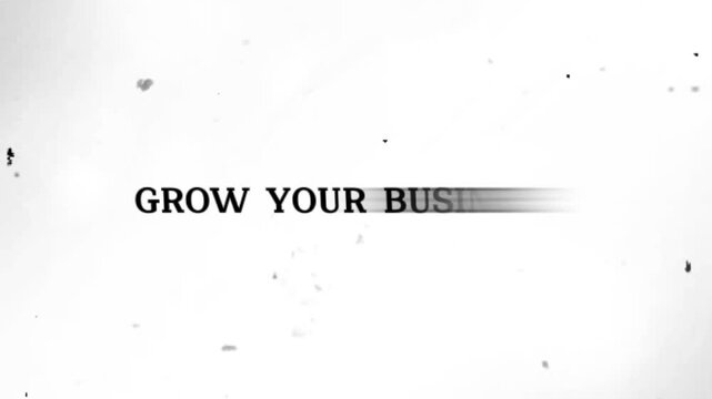 Blurry gray text on white background with black specks