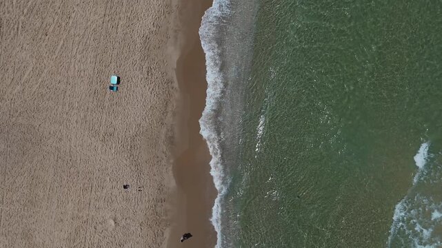 4K Slow Motion Top Down Drone Tracking Shoreline Waves, HaKeshet Beach Ashdod Israel, Waterline Surf and Beachgoers