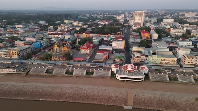 Birds-eye view of the Mekong River international border at dawn, showing the peaceful town of Mukdahan waking up