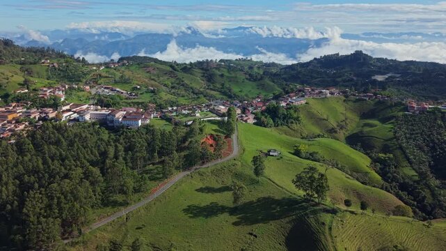 Aerial view of Jerico town nestled in lush green hills with mountain backdrop