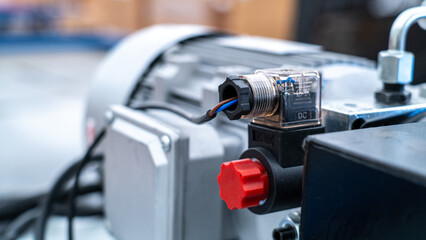 Fototapeta premium Electrical solenoid valve connecting to industrial hydraulic pump in factory