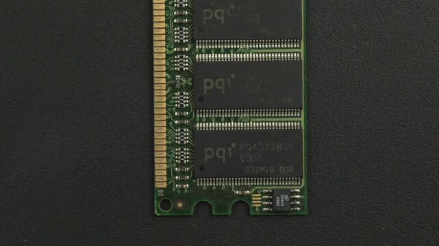 A green RAM module with gold contacts is partially visible on a textured black surface. Ideal for tech reviews or educational content on computer hardware.