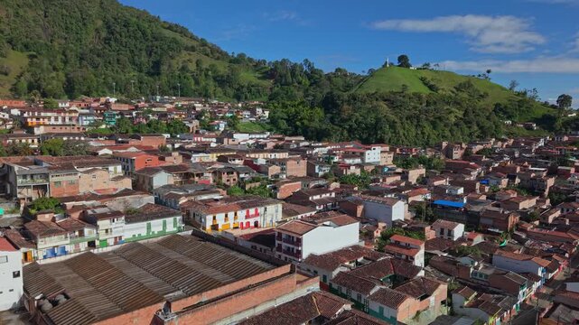 Aerial view of Jericos colorful town buildings nestled by lush green hills in Colombia