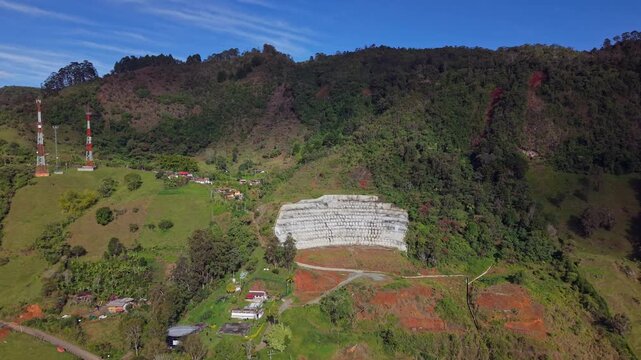Aerial view of lush green hills and rural landscape near Jerico, Colombia on sunny day