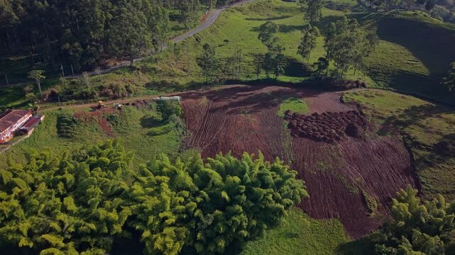 Aerial view of rural farmland and green hills near Jerico, Colombia on a sunny day