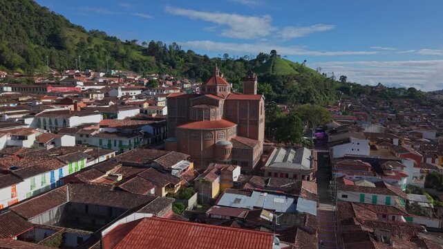 Aerial view of Jericos colorful town center with historic church and lush hills nearby