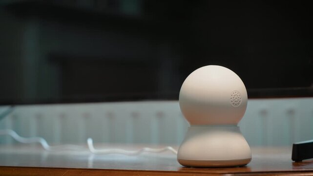 Indoor IP surveillance camera monitoring home interior for remote security observation. Smart connected security device supporting household protection and everyday video monitoring in modern living
