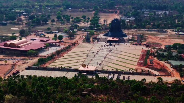 112-ft Adiyogi statue with Shri Mahashula, tourist and Suryakunda temple at Isha Foundation, Chikkaballapura, Bangalore, Karnataka, india. day time, crane shot, drone shot, 4k.