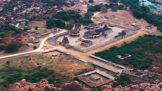 ancient ruins with The Stone Chariot, Vitthal Mandirv, Purandara mantapa, Haleya Mantapa and Tungabhadra river at nimbapura, Hampi, karnataka, india. day time, push back shot, drone shot, 4k.