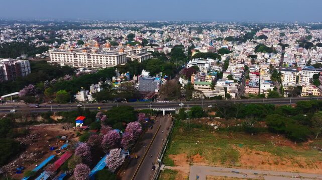 Mysore city with flyover, moving vehicles, buildings and JSS Hospital at Mysuru, karnataka, india. day time, zib shot, drone shot, 4k.