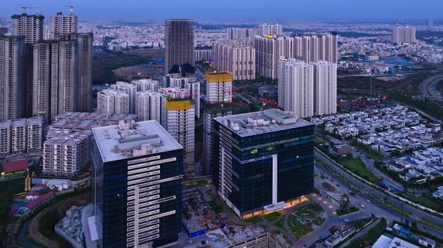 glass faded buildings with skyscraper, villas, under construction buildings and ORR at narsingi, financial district, Nanakramguda, hyderabad, telangana, india. day time, push in shot, drone shot, 4k.