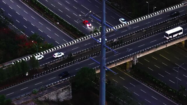Vehicles moving on Jawaharlal Nehru Outer Ring Road with Monopole Transmission Tower at nanakramguda, gachibowli, hyderabad, telangana, india. sun set time, blue hour, stable shot, drone shot, 4k.
