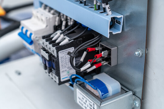 Electrical panel with circuit breakers and relays, controlling industrial power systems