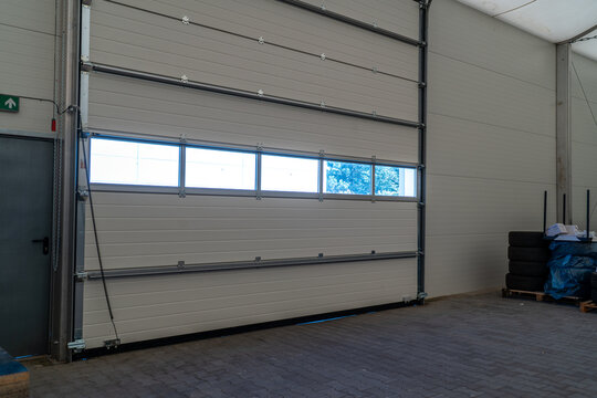 Sectional industrial door in a modern warehouse providing access and security