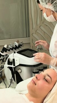 Cosmetologist Preparing Facial Treatment Machine