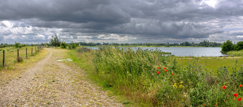 Thunderstorm over Negenoord protected area along the Meuse river near Dilsen-Stokkem, Belgium, designed for water storage and nature restoration