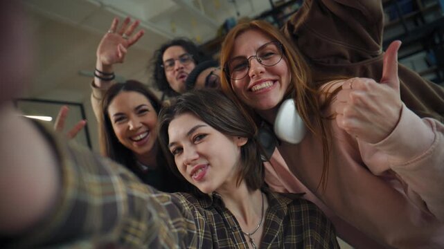 Group of friends taking a selfie in a library during afternoon study session and enjoying their time together with smiles and laughter