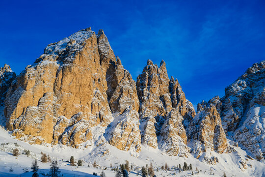 Majestic snow-covered mountain peaks under a clear blue sky.