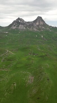 Majestic aerial view of the sedlo pass in durmitor national park. A flock of sheep peacefully grazes on the green mountain slopes