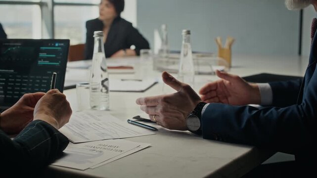Handheld shot of businesspeople in suits discussing oil transportation contract and shaking hands during corporate meeting. Clip is ideal for energy sector and B2B partnership marketing