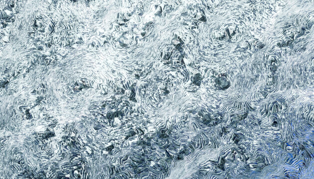 Abstract swirling pattern with shades of blue and white, resembling ocean waves or ice.
