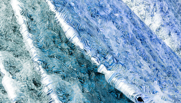 Abstract close-up of blue and white textured patterns in a layered wave-like design.