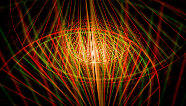 Abstract light patterns in vivid red and green radiating from a glowing center. 
