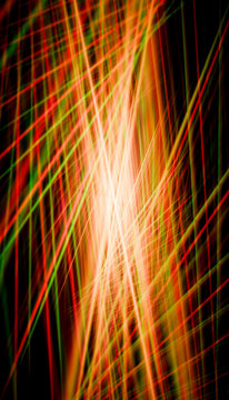 Bright intersecting red and green light trails creating a dynamic abstract pattern.