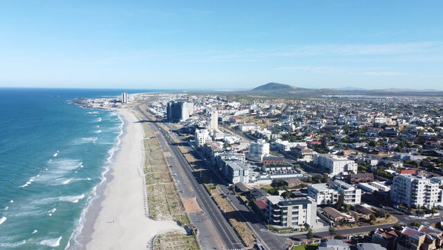 Aerial view of Tableview to Bloubergstrand beachfront and ocean with residential neighbourhood on the right of the Marine Drive or M14.