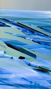 Abstract image featuring overlapping blue and green geometric shapes on a flat surface.