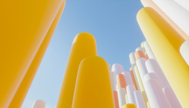 Tall, colorful cylindrical structures reaching towards a clear blue sky.