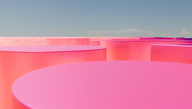 Pink cylindrical shapes against a clear blue sky create a surreal landscape.