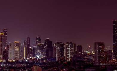 Fototapeta premium Cityscape of modern building in the night. Modern architecture office building. Skyscraper with beautiful evening sky. Business and financial center building. Apartment in the city with night light.