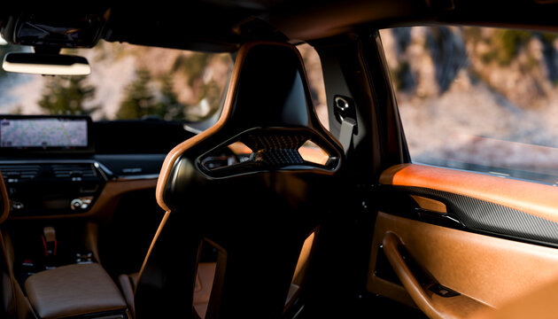 Luxurious car interior with leather seats and a scenic mountain view through the window.